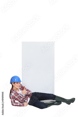 craftswoman lying in front of a blank poster © auremar