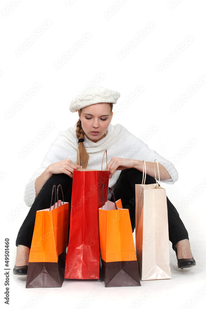 elegant woman looking in her shopping bags elegant woman looking in her shopping bags