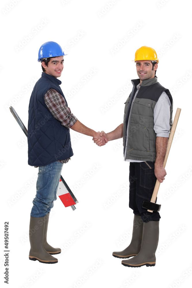 Construction workers shaking hands Construction workers shaking hands