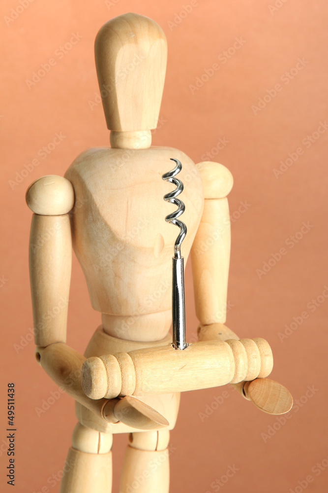 Mannequin with corkscrew, on brown background Mannequin with corkscrew, on brown background