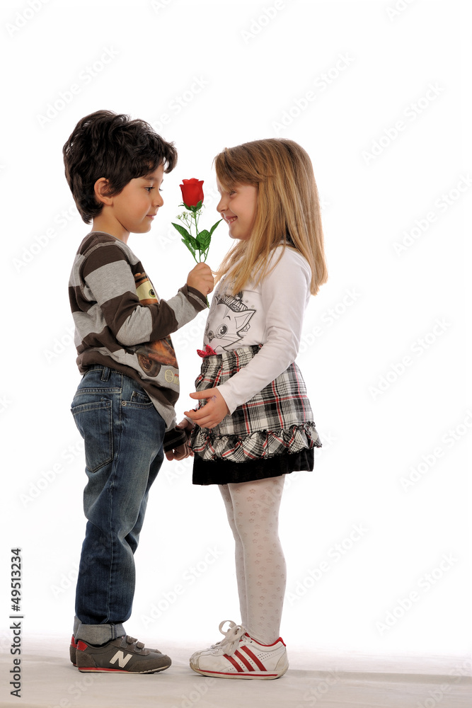 Lovely couple of kids. Boy offering flower... Happy Valentine's Lovely couple of kids. Boy offering flower... Happy Valentine's