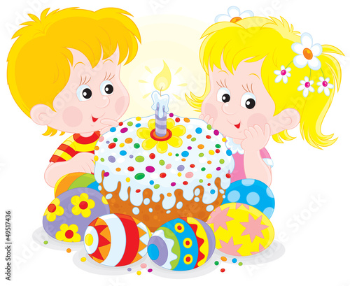 Girl and boy with a colorful Easter cake and eggs