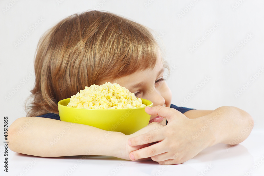 Beautiful child hugging a bowl of porridge favorite Beautiful child hugging a bowl of porridge favorite