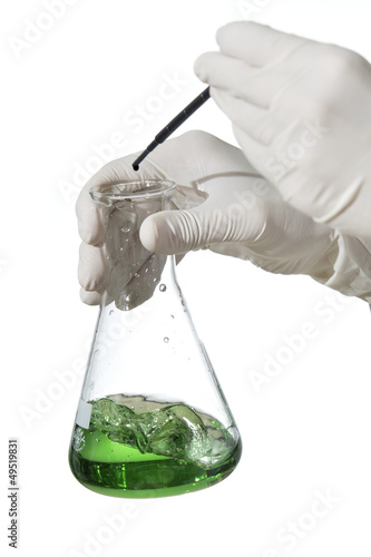 Matraz de Erlenmeyer con manos bióloga liquido verde photo