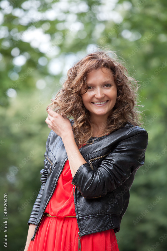 Portrait of young smiling woman in park. Portrait of young smiling woman in park.