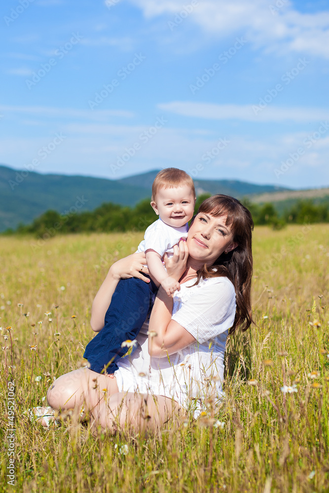 Family - happy mom and her son smiling at nature Family - happy mom and her son smiling at nature