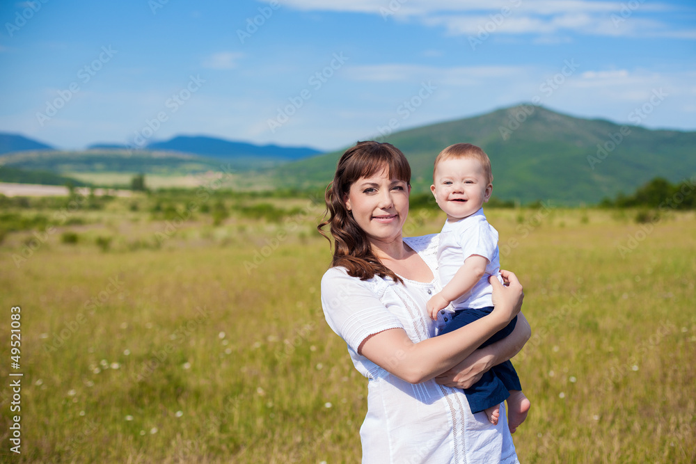 Family - happy mom and her son smiling at nature