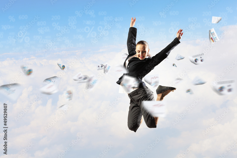 businesswoman in black suit jumping businesswoman in black suit jumping