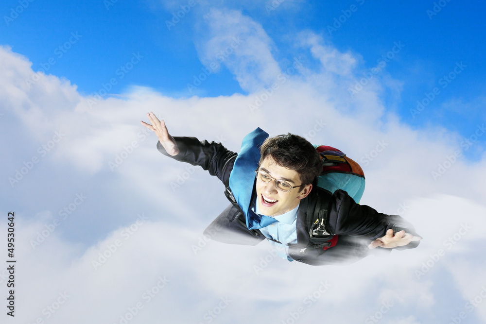 Young businessman flying with parachute on back Young businessman flying with parachute on back