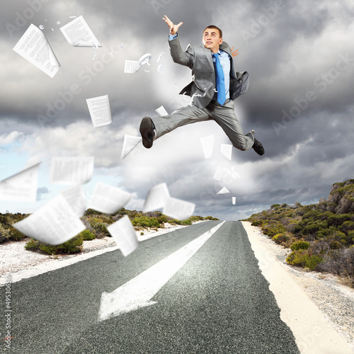 Businessman running on the road © Sergey Nivens