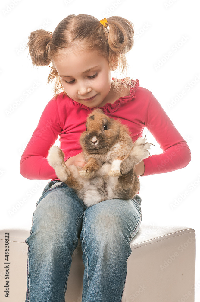 little girl playing with Easter bunny on a white background little girl playing with Easter bunny on a white background
