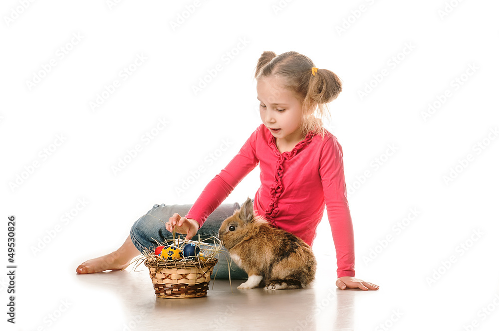 little girl playing with Easter bunny on a white background little girl playing with Easter bunny on a white background
