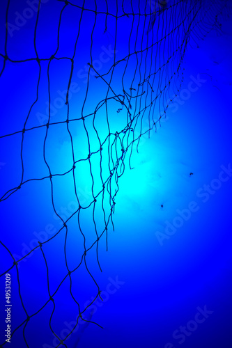 magic blue light over damaged red yarn grid, unknown science