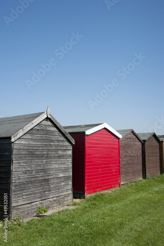 A bright red painted beach hut at Dovercourt, Essex, UK.