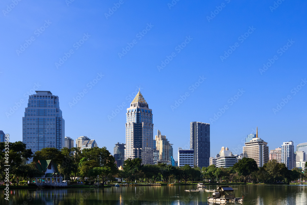 Business district cityscape from a park with blue sky