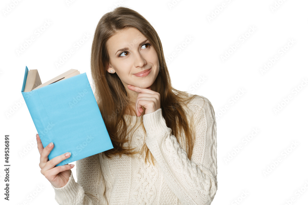Smiling woman holding book and looking at copy space
