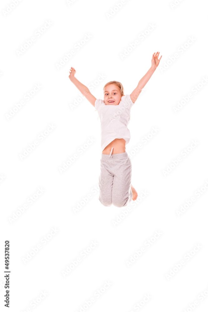 Adorable little girl jumping in air.