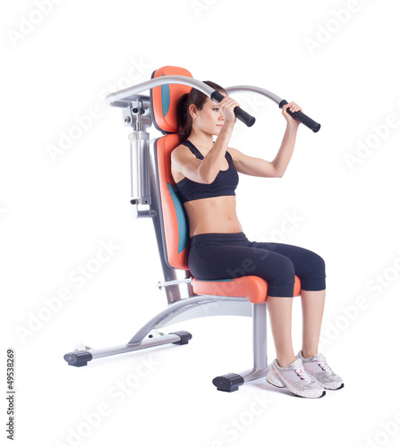 Brunette woman sitting on exerciser isolated photo