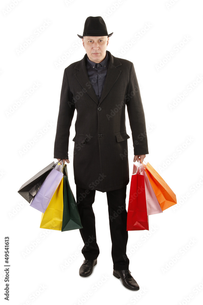 Man buyer is holding colorful shopping bags