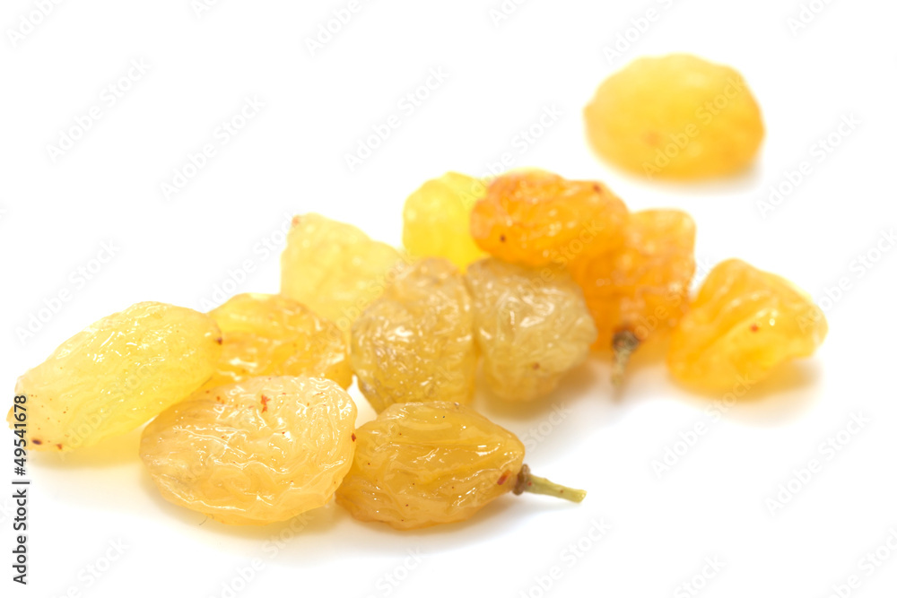 yellow raisins on a white background. macro yellow raisins on a white background. macro