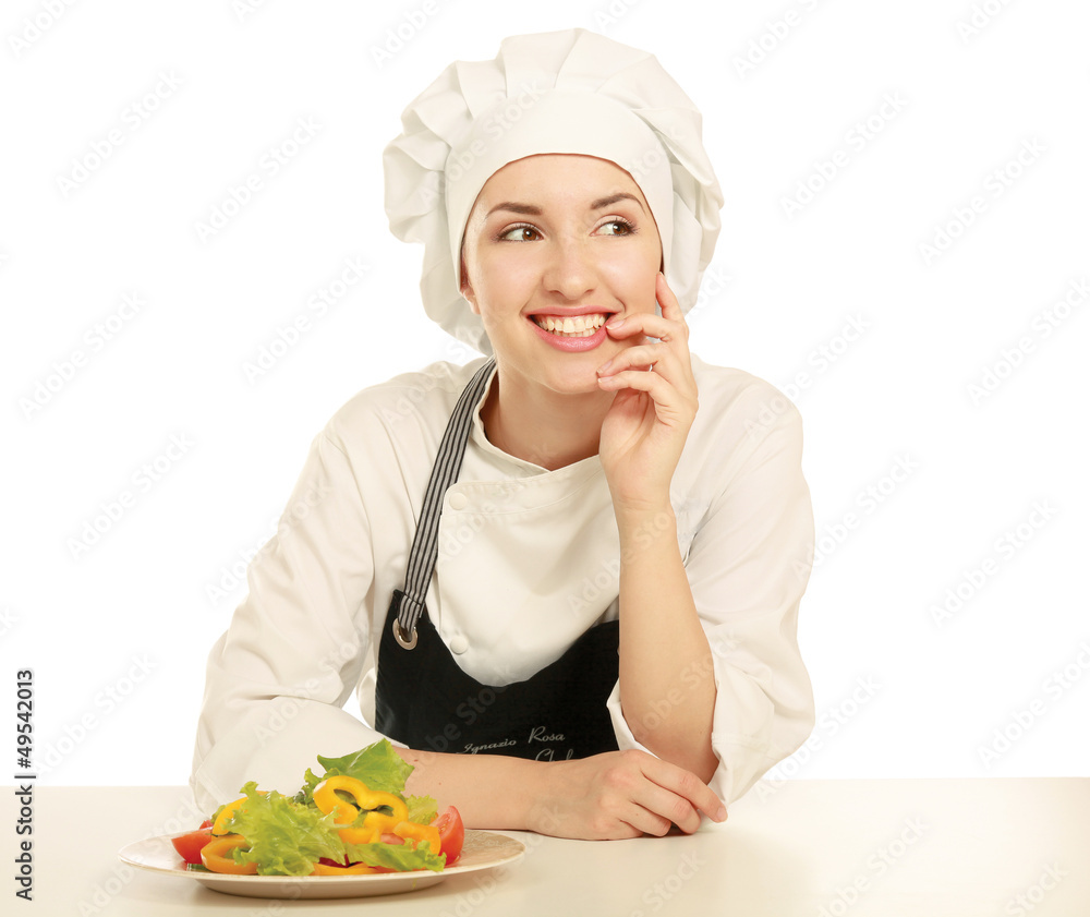 Pretty cook chief sitting at the table with salad Pretty cook chief sitting at the table with salad