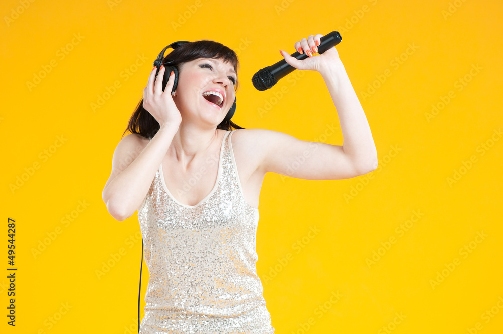 Expressive woman in headphones holding mike and singing Expressive woman in headphones holding mike and singing
