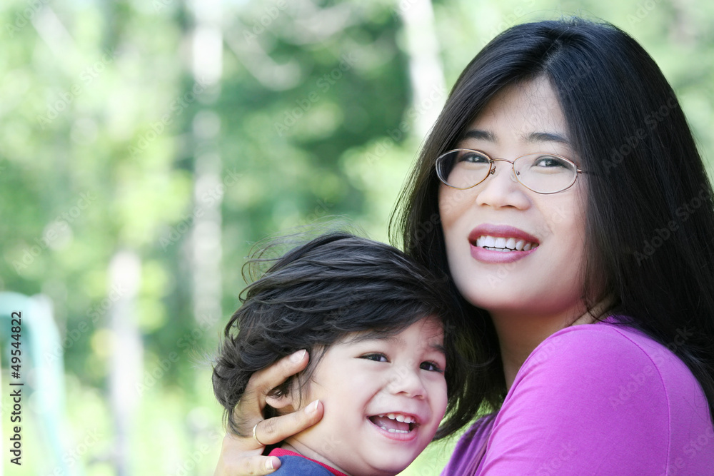Asian mother lovingly holding her son Asian mother lovingly holding her son