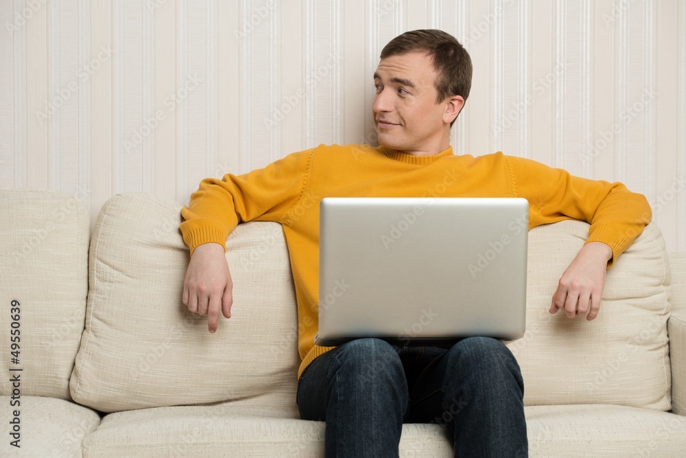 Man sitting on sofa with laptop Man sitting on sofa with laptop
