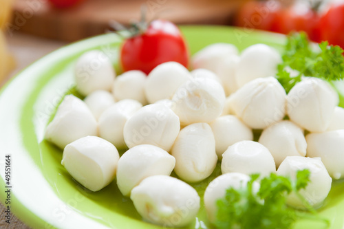 small balls of mozzarella on green plate