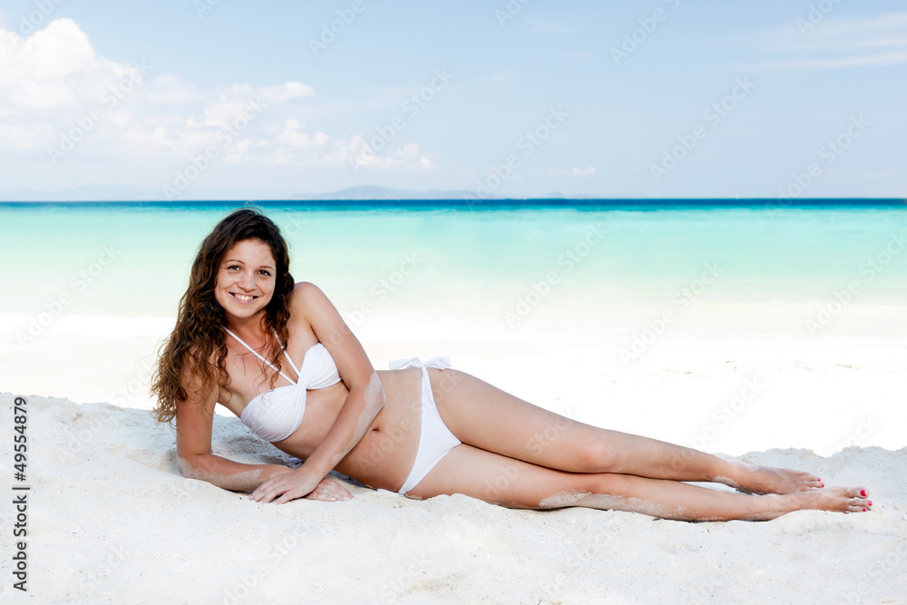 Portrait of a happy young woman posing while on the beach Portrait of a happy young woman posing while on the beach