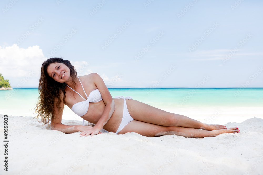 Portrait of a happy young woman posing while on the beach Portrait of a happy young woman posing while on the beach
