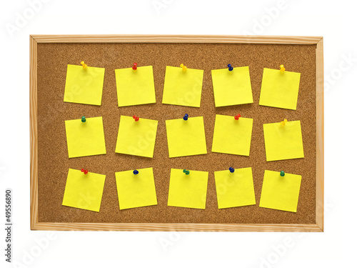 office cork board with yellow post it notes