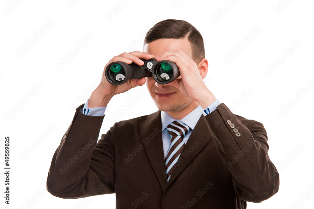 Closeup of a young business man looking through binocular isolat Closeup of a young business man looking through binocular isolat