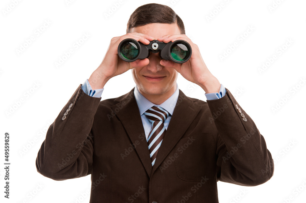 Closeup of a young business man looking through binocular at cam Closeup of a young business man looking through binocular at cam