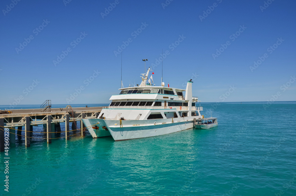 Catamaran Moored at a Jetty and Blue Sky Catamaran Moored at a Jetty and Blue Sky