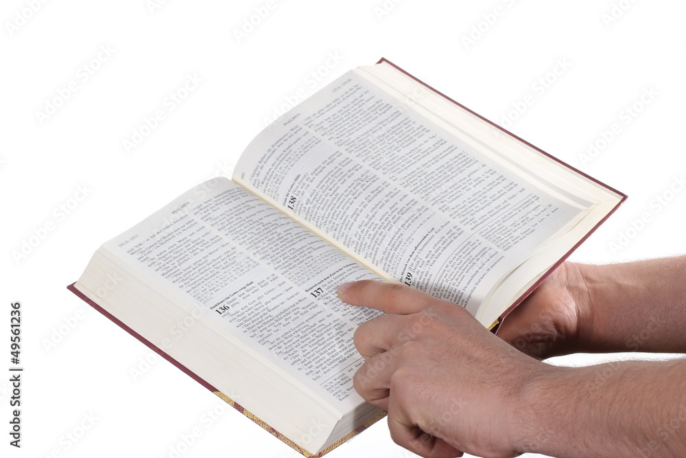 Fototapeta premium Praying hand hold an open bible