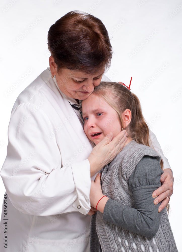 Senior pediatrician calming little girl Senior pediatrician calming little girl
