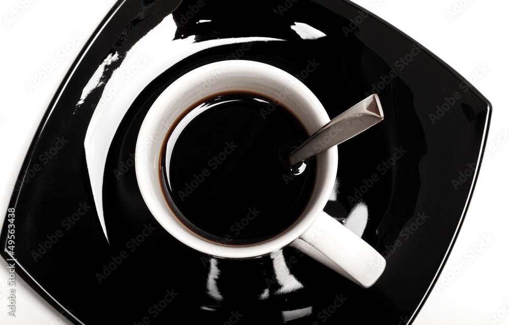 Coffee in white cup with spoon on black saucer isolated on white Coffee in white cup with spoon on black saucer isolated on white