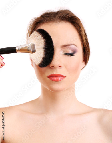 portrait of beautiful woman with make-up brush for powder,