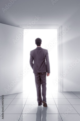 Man walking toward open Door