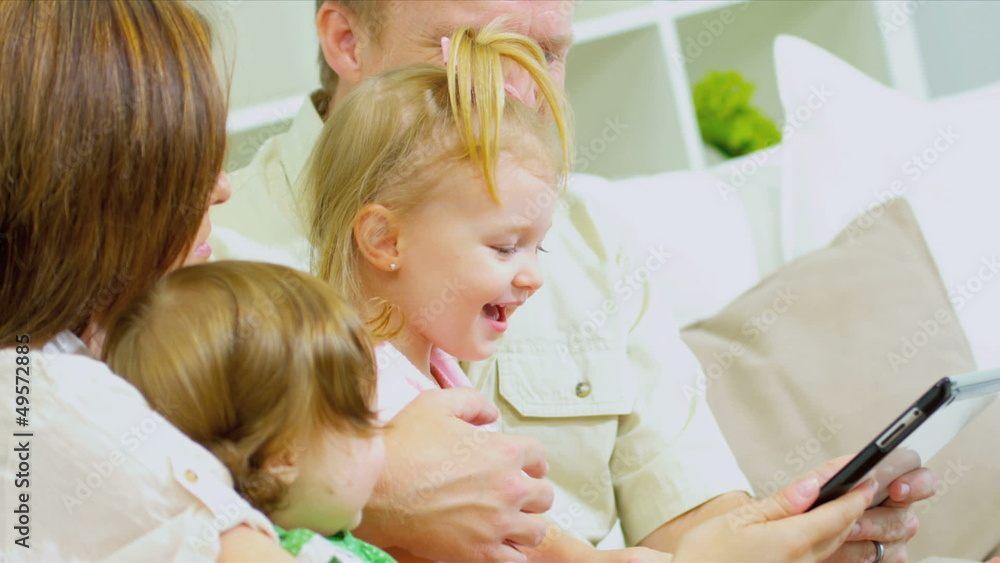 Pre School Girls Parents Using Wireless Tablet Close Up Pre School Girls Parents Using Wireless Tablet Close Up