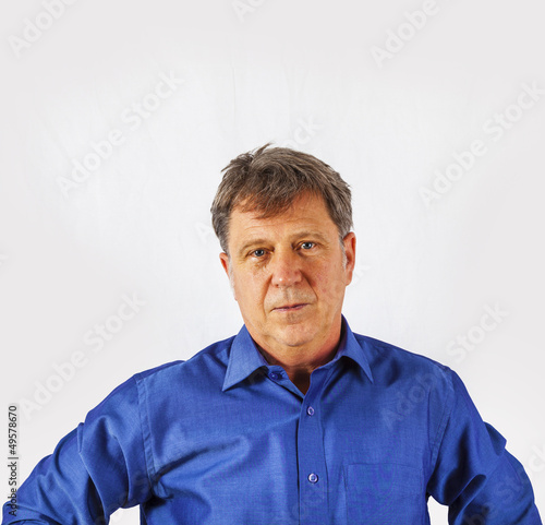 Portrait of a confident senior man standing on white background