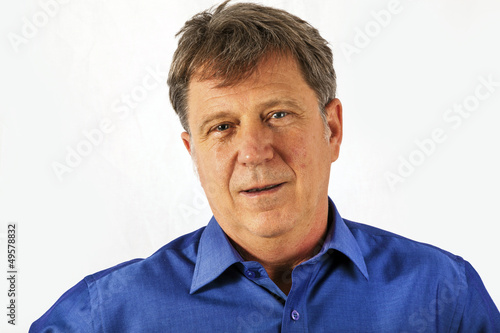 Portrait of a confident senior man standing on white background