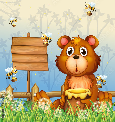 A bear and bees near a signage