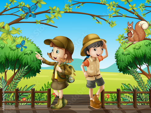 A girl and a boy at the wooden bridge