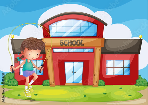 A girl playing in front of the school