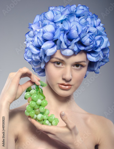 beautiful young girl with green grapes