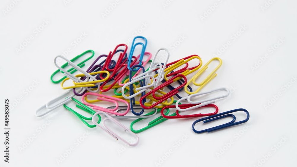 Colored paper clips on a white background Colored paper clips on a white background