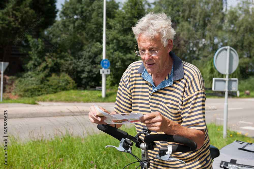 Reading the route map by biker Reading the route map by biker