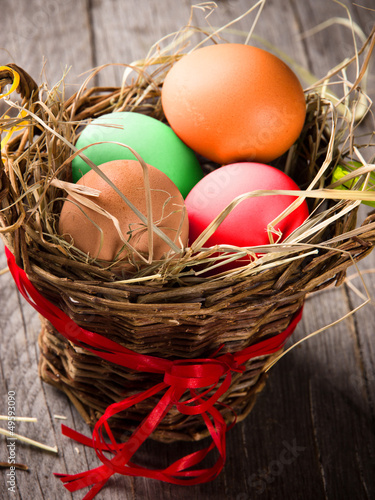 Colorful easter eggs in brown basket